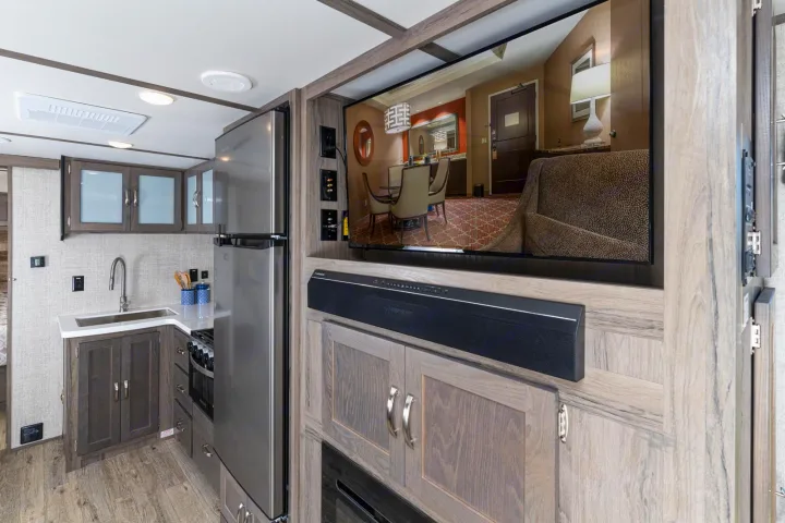 Step inside a modern RV rental, showcasing a functional kitchen area and entertainment center for your next adventure.. Gulf Stream Envision 2021