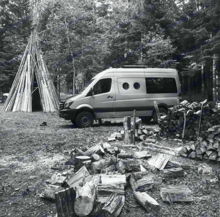Forest camp with a silver Sprinter RV rental, log tipi, & firewood. Experience unique van life adventure in nature.. Mercedes-Benz Sprinter 4x4 315CDI MWB 2015