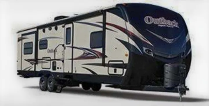 This light-colored travel trailer RV rental, ideal for camping adventures, features a dark front cap and multiple windows.. Keystone 316-UL 2014