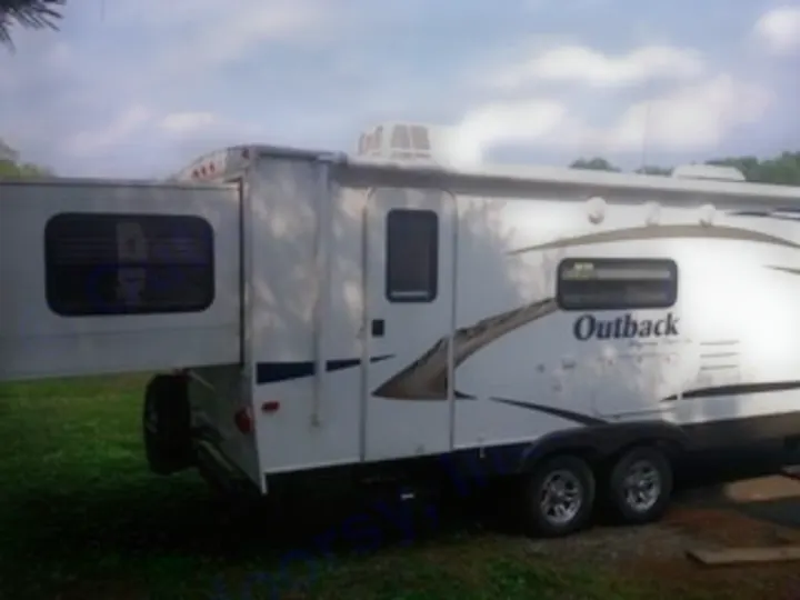 White Outback travel trailer with slide-out extended, perfect for your next RV rental camping adventure.. Keystone RV Outback 2011