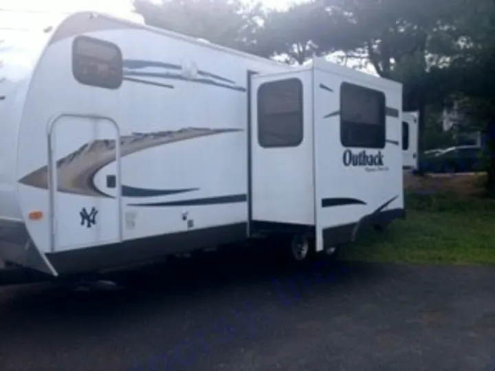 White Outback travel trailer, slide-out extended, perfect for your RV rental or camping trip.. Keystone RV Outback 2011