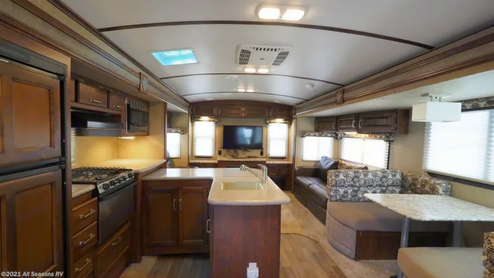 Spacious RV rental interior with full kitchen, dining, and living area.. Keystone Outback 2016