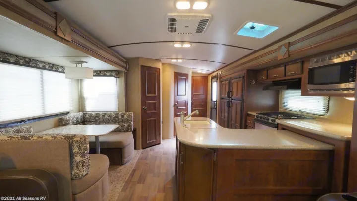 This RV rental offers a modern kitchen island, U-shaped dinette, and cozy living space, perfect for travel.. Keystone Outback 2016
