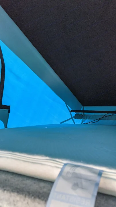 Cozy blue-lit RV rental interior with sleeping area and ambient lighting, perfect for your next camping adventure.. vw T6 2016