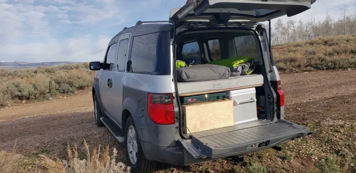 Honda Element camp build with bed, stove & cooler, ready for outdoor adventures. An ideal **RV rental** alternative for car camping.. Honda Element 2003