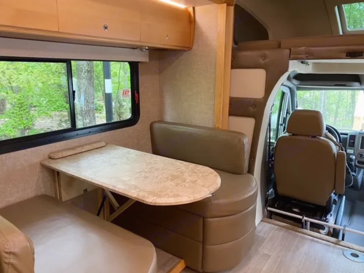 RV rental: Spacious interior featuring a cozy dining area, large window, overhead bunk, and front cabin. Ready for adventure!. Tiffin Motorhomes Wayfarer 2019