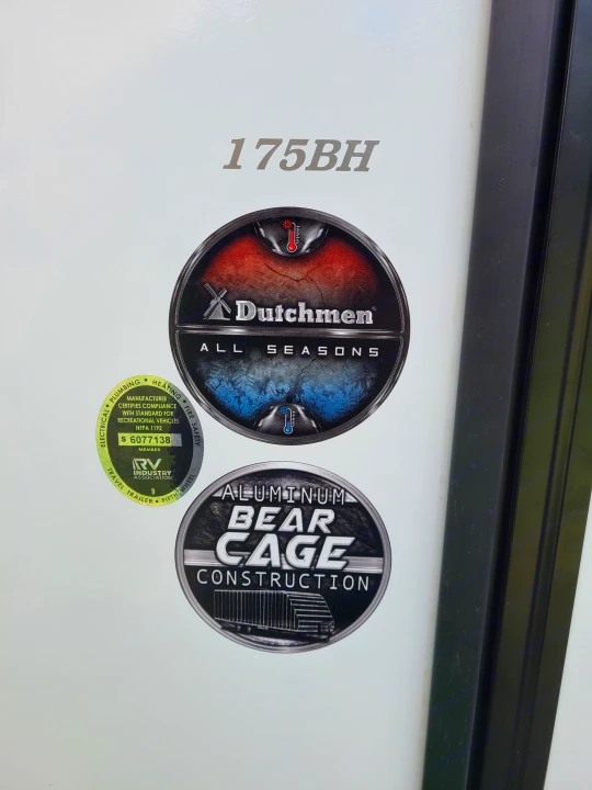 Side of a Dutchmen 175BH rv rental, featuring "All Seasons" and "Aluminum Bear Cage Construction" decals with RVIA certification.. Dutchmen Kodiak 2021