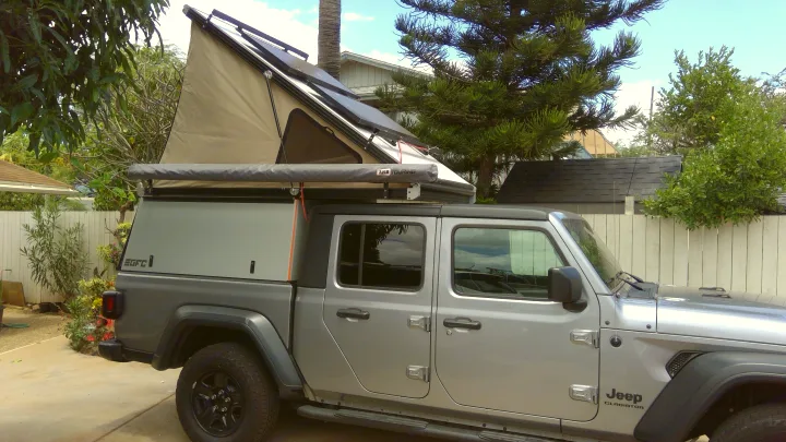 Silver Jeep Gladiator overland rig with a GFC camper & rooftop tent, ready for your RV rental adventure.. Jeep Gladiator 2020