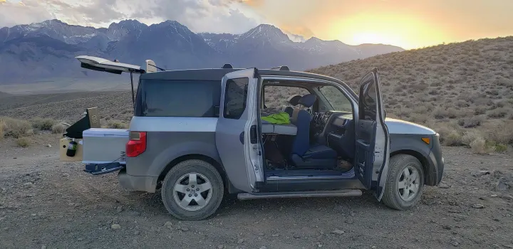This Honda Element RV rental is perfectly set up for off-grid camping in a scenic mountain landscape, with a bed inside & kitchen out back.. Honda Element 2003