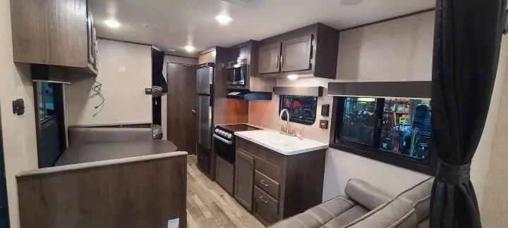 Clean RV rental interior featuring a full kitchen, dinette, and sofa. Ready for your next adventure.. Jayco Jay Flight 2021