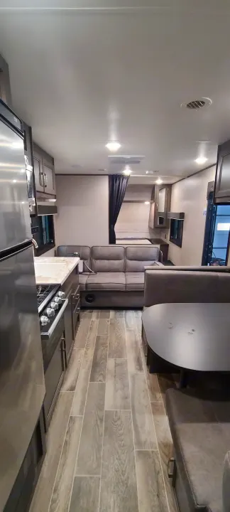 Spacious rv rental interior with kitchen, living space, dinette, and a private bedroom.. Jayco Jay Flight 2021
