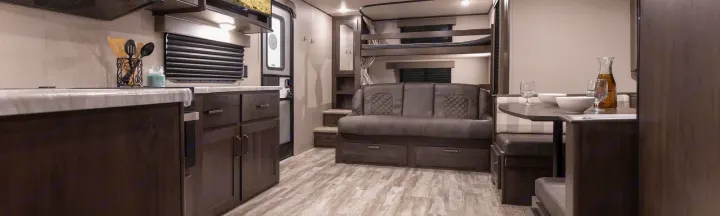 Spacious RV rental interior with full kitchen, cozy dinette, sofa, and bunk beds, perfect for family travel.. Grand Design Other 2022