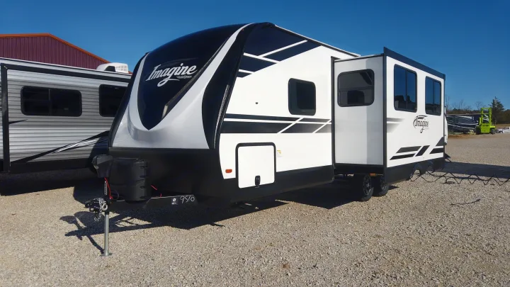 Modern white & black Imagine travel trailer on a gravel lot, slide-out extended. Ideal for an RV rental adventure!. Grand Design Other 2021