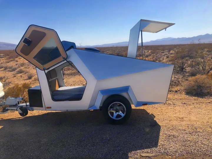 Explore the desert! This unique, angular silver travel trailer (RV rental) features open hatches & a comfortable bed.. Polydrop K-20 2020