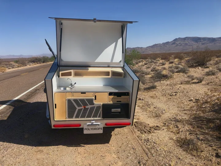 Experience outdoor cooking with this Polydrops camper's rear kitchen. An ideal RV rental for off-grid travel.. Polydrop K-20 2020