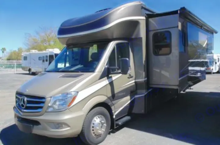 Modern tan and gray Mercedes-Benz Sprinter Class C motorhome with an extended slide-out, perfect for RV rental.. Dynamax Corp Isata 2016