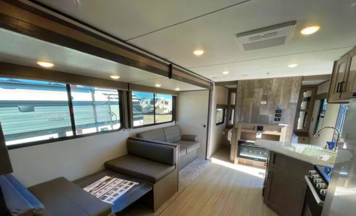 Bright & spacious modern RV rental interior with dinette, living area, and full kitchen.. Other Hideout 2021