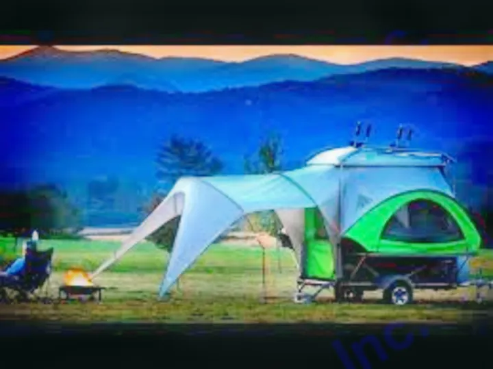 Experience outdoor adventure! This compact RV rental shows a small camper with tent extension and campfire at dusk.. Other Other 2018