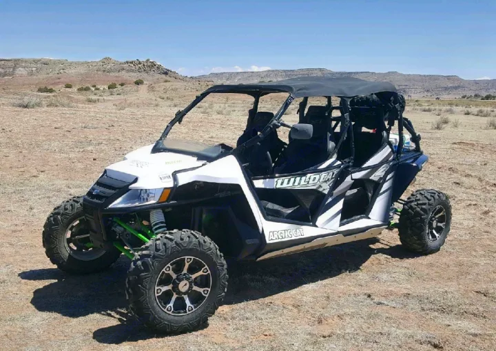 White Arctic Cat Wildcat UTV in desert. Get off-road thrills beyond an RV rental experience!. Artic Cat Side by Side 2015