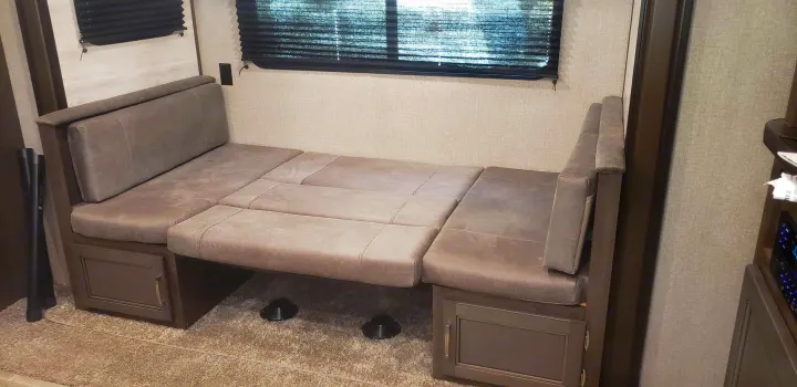 RV rental interior: This convertible dinette is transformed into a comfortable bed with built-in storage below.. Jayco Jay Flight 2021