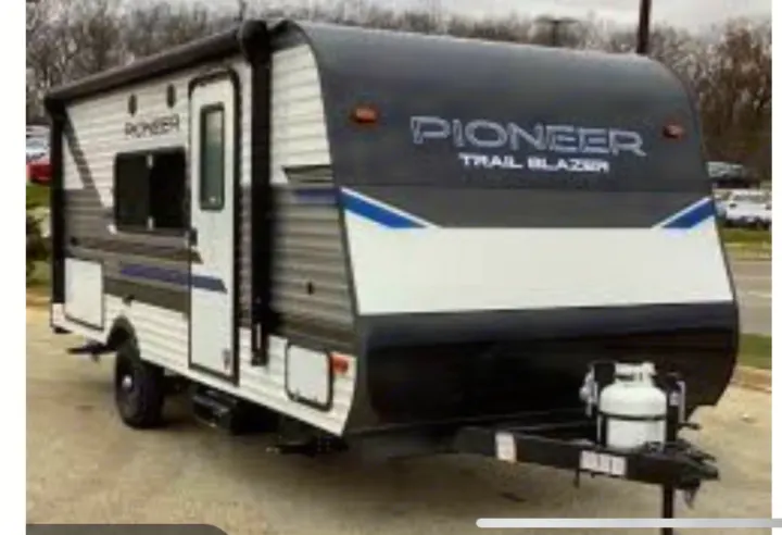 Front view of a black and white Pioneer Trail Blazer travel trailer, perfect for RV rental and outdoor adventures.. Pioneer BH170 2021