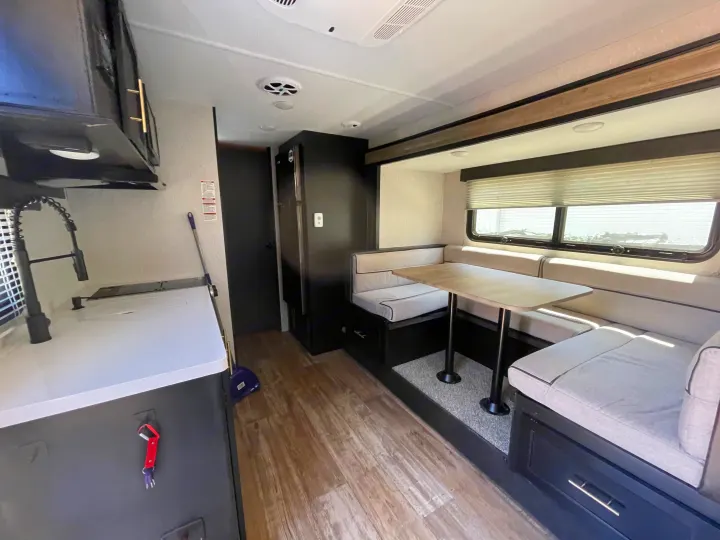 RV rental interior: modern kitchen, comfortable dinette seating, and bright living area for road trips.. Forest River Cherokee Wolf Pup 2021