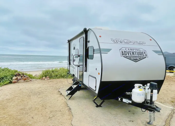 This Wolf Pup RV rental from Camping Adventures is perfectly parked by the ocean, offering a great beach camping experience.. Forest River Cherokee Wolf Pup 2021
