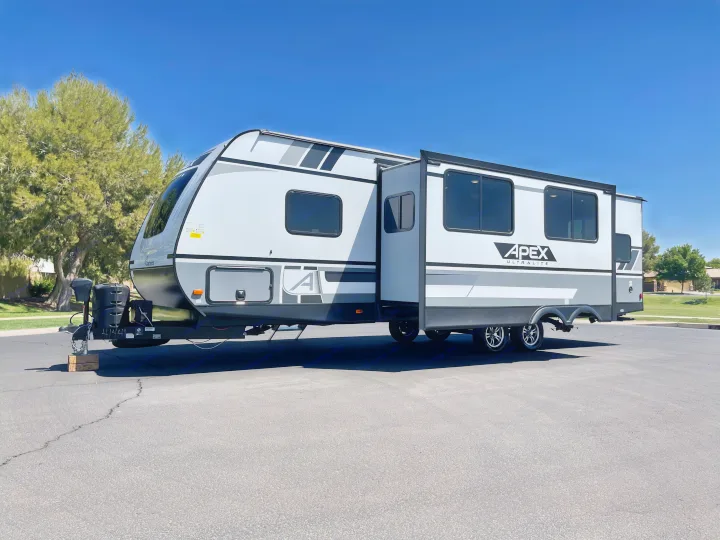 Bright white Apex Ultralite travel trailer with extended slide-out, perfect for an rv rental getaway.. Coachmen Apex 2021