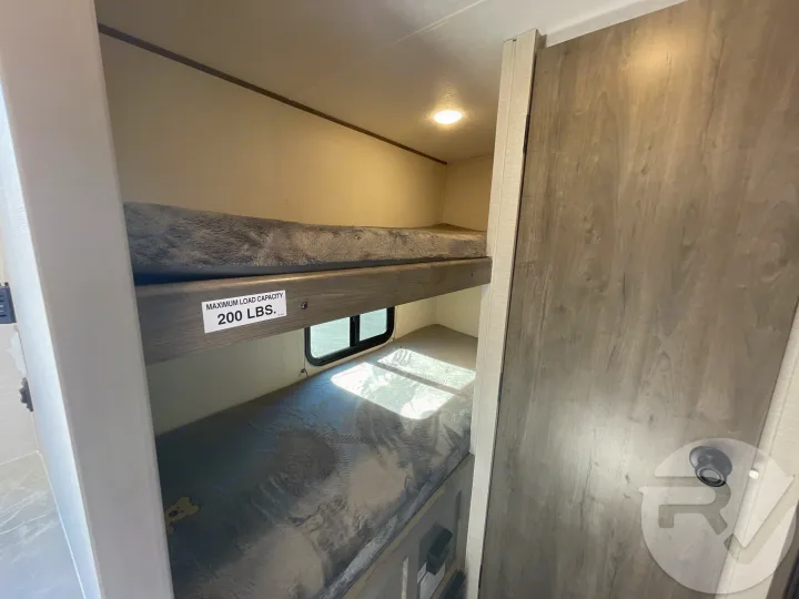 RV rental bunk beds, capacity 200 lbs. Cozy sleeping space for family trips.. Coachmen Apex 2021