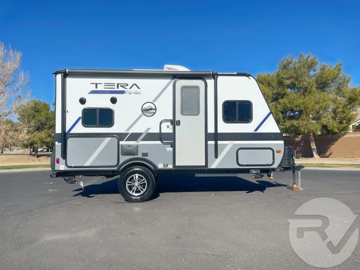 Side view of a sleek white & gray TERA Apex travel trailer, ready for your RV rental. An excellent camper for any journey.. Coachmen Apex 2021