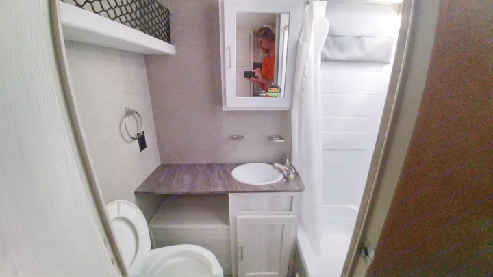 Clean RV rental bathroom with toilet, sink, and shower/tub combo. Ideal for your next road trip adventure.. Forest River Rockwood 2019