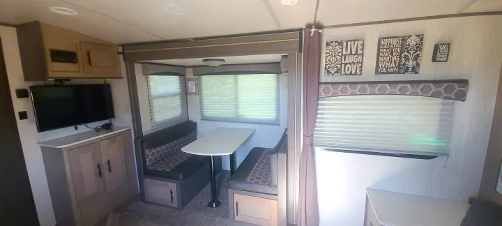 RV rental: inviting living area with a comfortable dinette, TV, storage, and inspirational wall art.. Cruiser Rv Corp Shadow Cruiser 2020