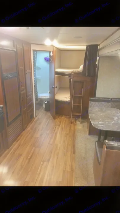 RV rental interior showcasing a modern kitchen, full bathroom, dinette, and comfortable bunk beds for travel.. Jayco Jay Flight 2016