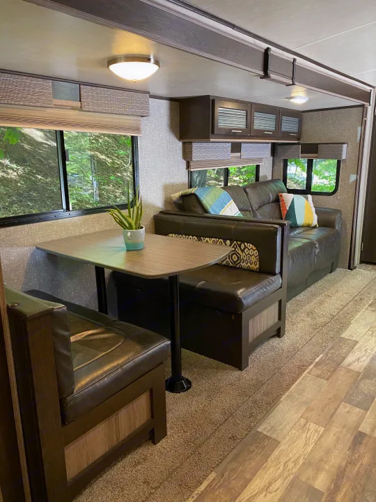 Inside a modern RV rental: Comfortable dinette and sofa provide a cozy living space with nature views.. Other Fun Finder 2017