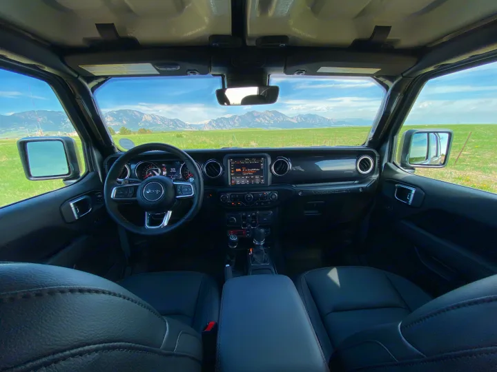 Inside a Jeep Wrangler, facing stunning mountains. Perfect for a road trip adventure or complementing an RV rental journey.. Jeep Wrangler Unlimited Rubicon 392 2021