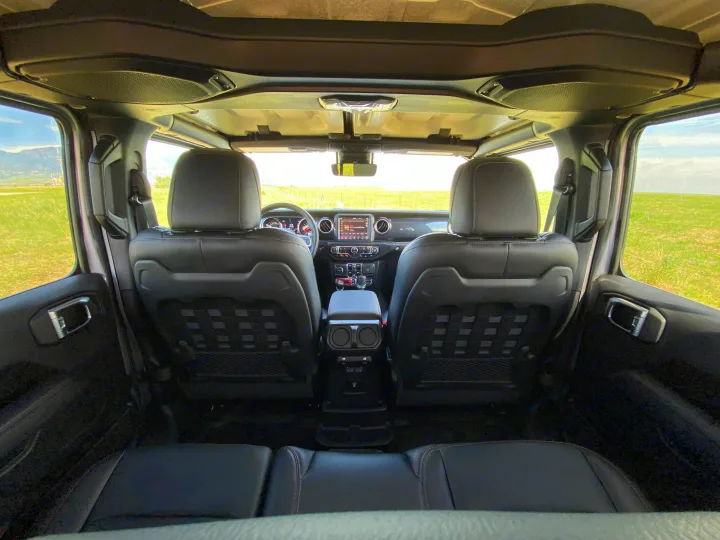 Inside a comfortable, adventure-ready SUV, ideal for your next RV rental road trip. View from rear seats to dashboard.. Jeep Wrangler Unlimited Rubicon 392 2021