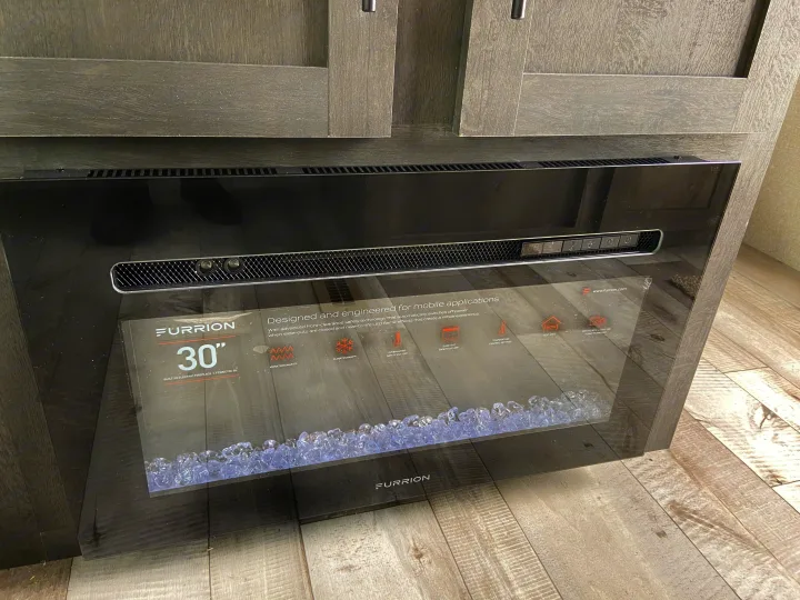 Enjoy cozy nights in your RV rental with this Furrion 30" electric fireplace, designed for mobile comfort and ambiance.. Sportsmen LE 2021