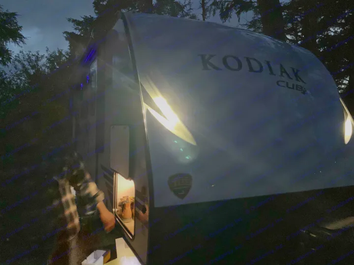 Additional lights are on the front of the trailer, and above the hitch. here you can also see the blue lights on speakers and the under-awning strip. Dutchmen Kodiak 2021