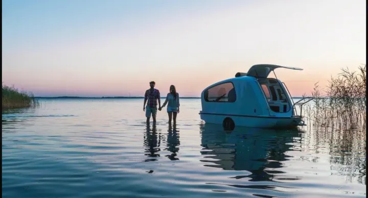 Couple enjoys their unique floating camper, a perfect water RV rental for lake adventures at sunset.. Sealander Sealander 2021