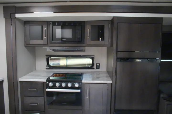 Propane stove and cookware included.

Refrigerator has the "off-grid" solar power feature. . Grand Design Transcend Xplor 2021