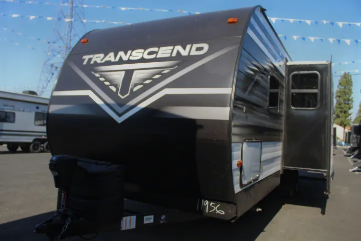 Transcend travel trailer RV with distinct T-logo in dark gray, perfect for RV rental.. Grand Design Transcend Xplor 2021