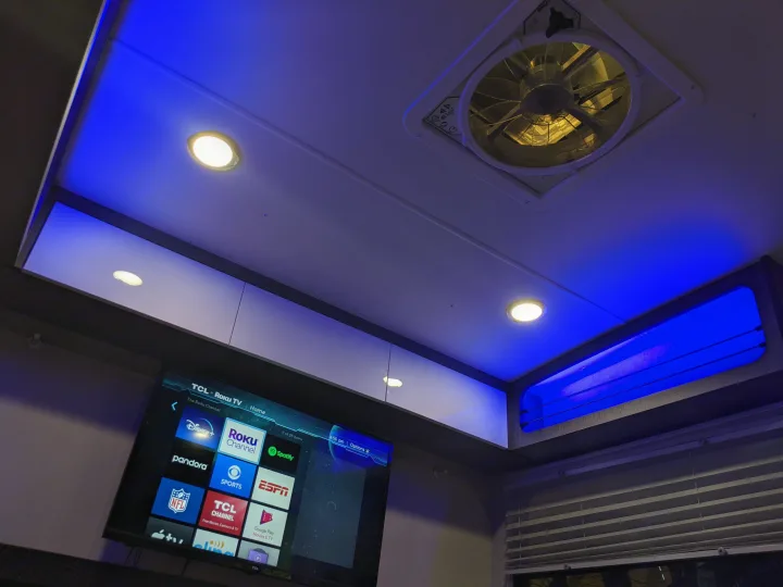 Inside an **rv rental**: Roku TV, blue LED backlighting, and a ceiling fan create a modern entertainment space.. InTech RV InTech RV Trailer 2021