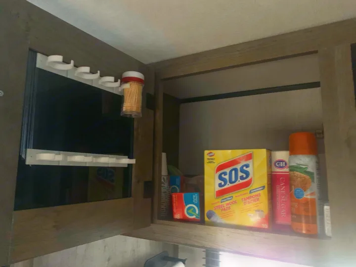 RV rental kitchen/cleaning cabinet with SOS pads, sugar, cooking spray, and smart door storage for toothpicks & small items.. Pioneer BH170 2021