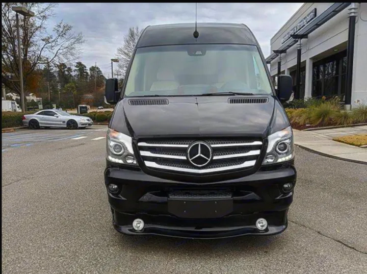 Front view of a sleek black Mercedes Sprinter van, ideal for your next luxury rv rental.. Mercedes 3500 2018