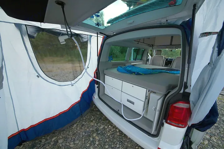 RV rental: Rear tent with outdoor shower and integrated bed/storage in a camper van for versatile camping adventures.. Volkswagen California Beach T6.1 2023