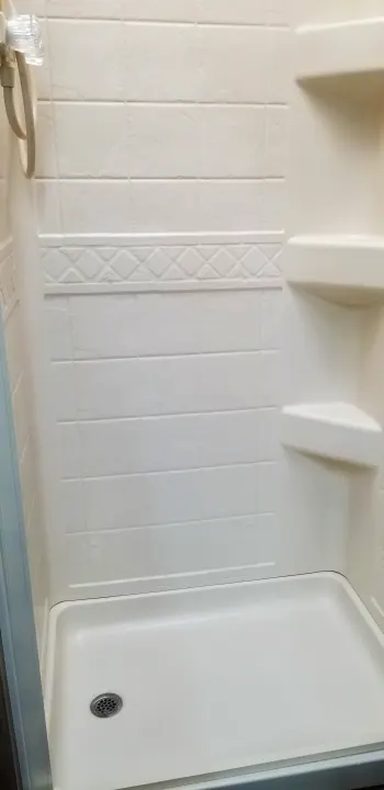Step inside this clean, compact RV rental shower, featuring built-in shelves and a decorative tile pattern.. Mercedes Benz Four Winds 2018