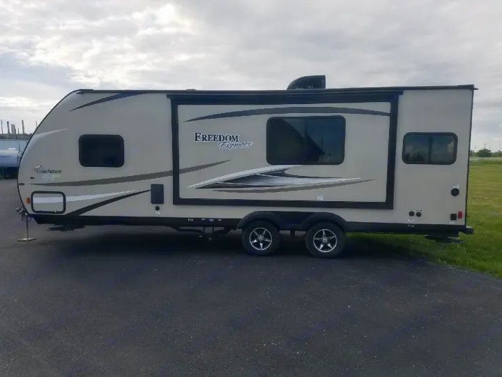 Experience freedom on the road! This beige Freedom Express travel trailer is perfect for your next rv rental adventure.. Coachmen Freedom Express 2017