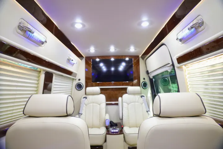 Experience luxury in this RV rental: pristine cream leather seating, large TV, and ambient ceiling lights.. Mercedes 3500 2018