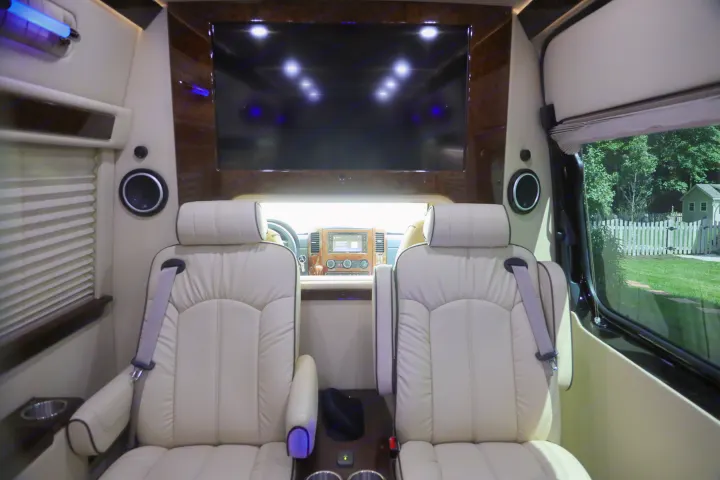 Experience ultimate comfort in this premium RV rental interior, featuring plush seating, a large screen, and ambient lighting.. Mercedes 3500 2018