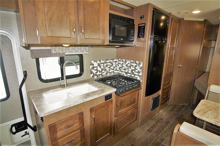 RV rental: This spacious RV kitchen features a double sink, gas range, microwave, and large refrigerator.. Winnebago Outlook 2019
